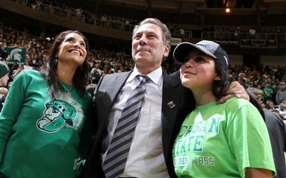 Coach Tom  Izzo   of  Michigan  State  stands  with  his  wife Lupe and  daughter Raquel  moments  after  the  team's  stunning  upset  of  Louisville .
