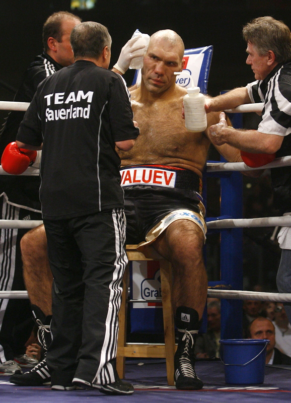 Valuev seated  in his  corner  listens to  his  trainers give  him  some  much needed advice  during  his  title  defense  against the  challenger  David   Haye.    Valuev  would  suffer  the  second  loss  of  his   professional  career   losing a  unanimous  12  round   decision to   David Haye.     picture  appears   courtesy  of afp dpp/getty  images  /  Timm  Schamberger  ................