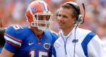 Gatots' player Tim Tebow (15) and his coach Urban Meyer discuss their options during a game. photo appears courtesy of Getty Images/ Chris Dickson ...................