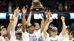 The Duke Blue Devils hold up the trophy after a 78-71 win over the Baylor Bears in the south regional final of the NCAA men's basketball tournament at Reliant Stadium in Houston on Sunday. photo appears courtesy of Getty Images/ Ronald Martinez ...