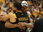 West Virginia's Da'Sean Butler and Joe Mazzulla hug after the game. Butler scored 18 points and Mazulla pitched in a career-high 17 to help West Virginia hold off the Wildcats.