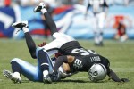 Stanford Routt (26) of the Oakland Raiders tackles Bo Scaife (80) of the Tennessee Titans during the NFL season opener at LP Field on September 12, 2010 in Nashville, Tennessee. The Titans defeated the Raiders 38-13. Joe Robbins/Getty Images
