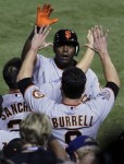 San Francisco Giants' Edgar Renteria, right, is congratulated by Pat Burrell after Renteria hit a three-run home run during the seventh inning of Game 5 of baseball's World Series against the Texas Rangers Monday, Nov. 1, 2010, in Arlington, Texas. AP Photo/Tony Gutierrez ........