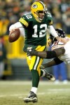 Quarterback Aaron Rodgers (12) of the Green Bay Packers attempts to break free from Tommie Harris (91) of the Chicago Bears at Lambeau Field on January 2, 2011 in Green Bay, Wisconsin. Photo by Matthew Stockman/Getty Images .......