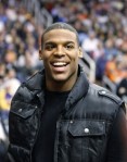 Auburn quarterback Cam Newton smiles as fans call out his name while he takes in the Los Angeles Lakers-Phoenix Suns NBA basketball game in Phoenix on Wednesday, Jan. 5, 2011. Auburn and Oregon are scheduled to play in the BCS championship college football game Monday in Glendale, Ariz. AP Photo/Ralph Freso .........