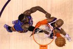 Phoenix Suns' Vince Carter , right, scores as New York Knicks' Amare Stoudemire defends during the first quarter of an NBA basketball game Friday, Jan. 7, 2011, in Phoenix. The Knicks defeated the Suns 121-96 . AP Photo/Ross D. Franklin ..............